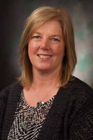 woman with blond hair wearing dark sweater