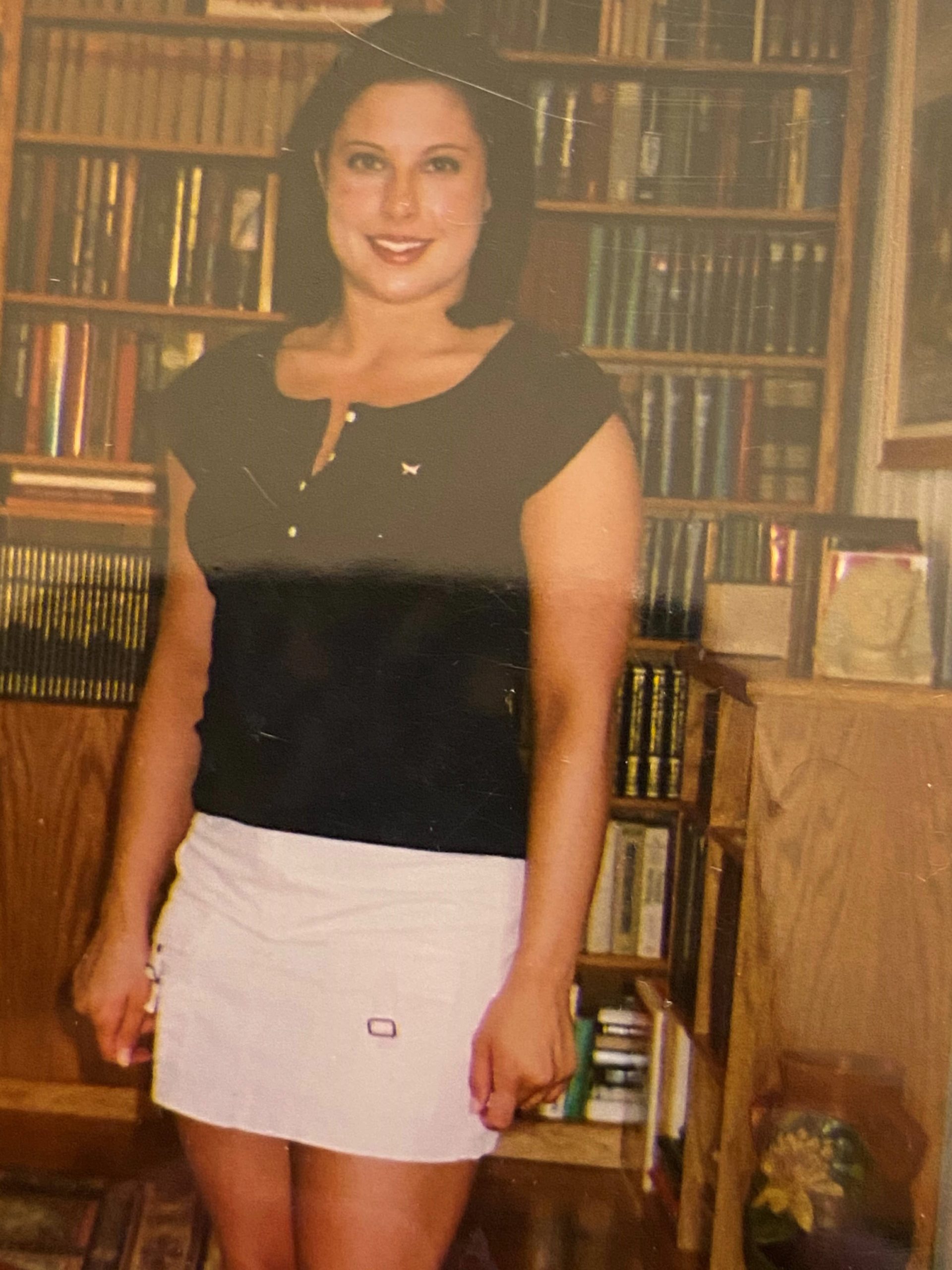throwback photo of caitlin standing in a library
