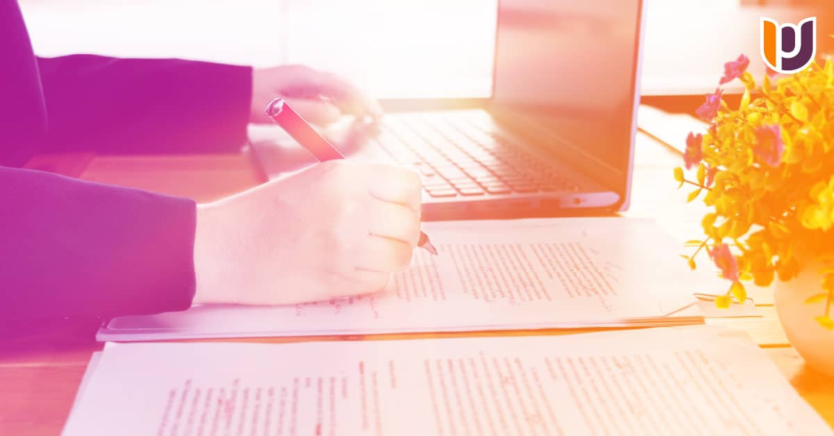 a person sitting at desk writing a paper