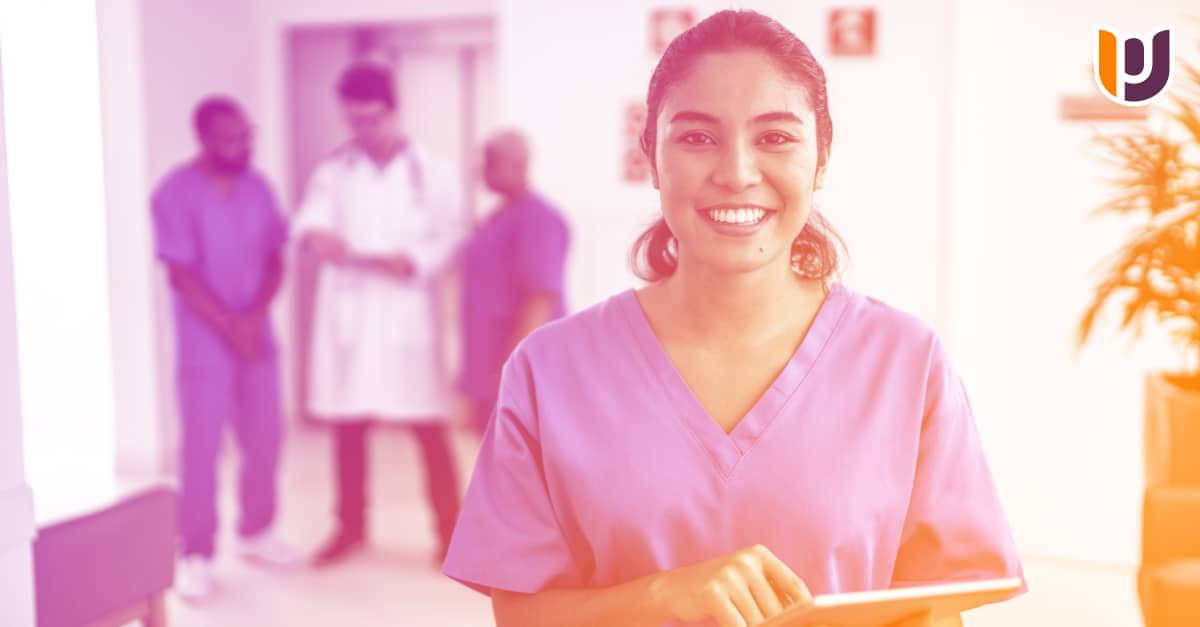 nurse in scrubs with clipboard