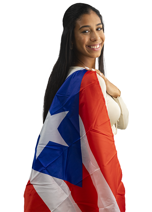 Tai Pagan smiling with the Puerto Rican flag draped over her shoulder